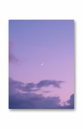 A serene twilight sky with soft, purple-tinged clouds and a delicate crescent moon glowing above. The dreamy evening atmosphere captures calm, wonder, and the beauty of dusk.