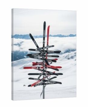 Unique ski signpost on a snowy mountain peak