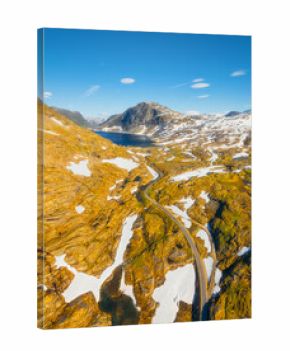 Nature in Norway. Drone view of wild Norway. Road among the rocks and mountains. Bright sunshine in the daytime. Vacation and travel in summer Norway. Background, wallpaper, postcards.