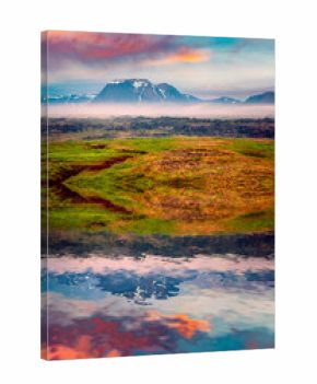 Typical Icelandic landscape with foggy mountains on the horizon.