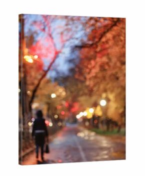 Evening in an autumn park, abstract blurred background, changing seasons in the city
