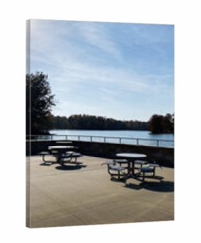 Lakeside terrace with round picnic tables overlooking calm water in Southern Illinois USA