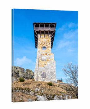 The lookout tower stands tall on Wysoki Kamien in the Jizera Mountains, Poland. Surrounded by natural beauty, it offers stunning views of the landscape and surroundings.