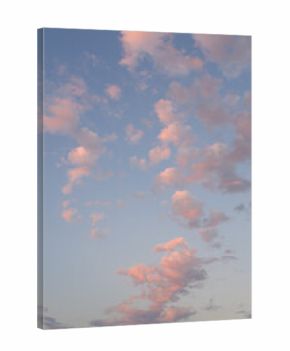 Early evening sky with fresh air and freedom, white fluffy clouds in blue sky with hints of pink from the sun below the horizon, as a nature background 