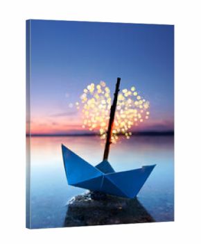 magical blue paper boat with lantern at the beach - romantic evening