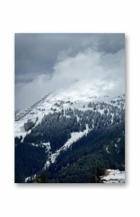 Scenic view of snow covered mountain and snow line in the ski region of Saalbach-Hinterglemm in the Austrian alps against cloudy sky