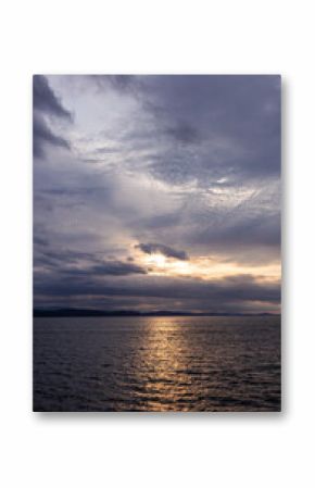 Scenic Sunset Over Vancouver Island, BC Captured with Cloudy Skies and Reflective Ocean Water