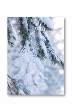 white dream catcher in snowy forest. beautiful winter background. Spiritual protection amulet, ethnic Shaman native amulet, symbol protection of dreams. Magic talisman for soul relax