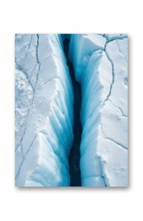 Majestic glacier with blue ice crevices and intricate patterns on white surface