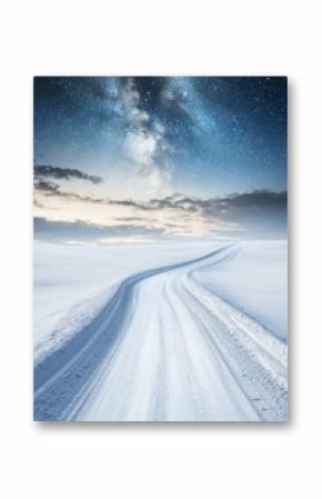 A road leading towards a colorful sunrise between snow-covered trees with the milky way across the sky in the distance