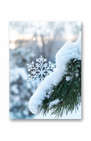 winter nature background. decorative snowflake on snowy pine tree close up. symbol of Christmas and New Year holidays. winter festive season. copy space