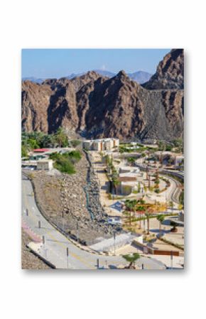 view of Hatta Sustainable Waterfalls, an eco-friendly tourist attraction in Dubai Hatta town. Featuring modern design, lush palm trees, and water channels, it promotes green tourism