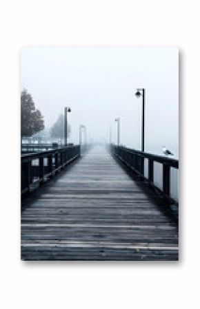 Long Wooden Pier Extending into Foggy Water