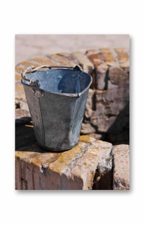 A water well with an old bucket