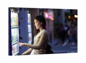 Japan vending machines - Tokyo woman buying drinks