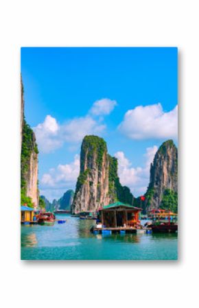 Floating fishing village and rock island in Halong Bay, Vietnam, Southeast Asia. UNESCO World Heritage Site. Junk boat cruise to Ha Long Bay. Landscape. Popular landmark, famous destination of Vietnam