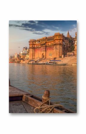 Ganges river boat ride at sunset overlooking the ancient Varanasi city, India.