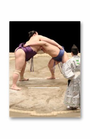 Two sumo wrestlers (rikishi) and the referee (gyoji) during a sumo fight in a tournament, professional sumo wrestling match