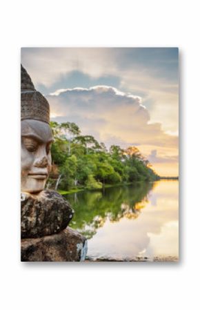 Stone face Asura and sunset over moat. Angkor Thom, Cambodia
