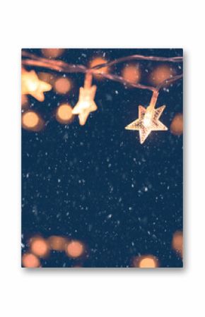 Defocus Christmas stars lights with falling snow, snowflakes, Winter and new year holidays. copy space.