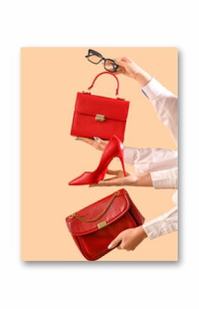 Female hands with stylish women's bags, eyeglasses and high heels on beige background