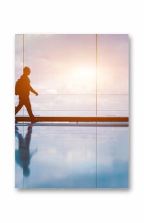 Family at airport travelling with young child walking to departure gate. Family vacation and holidays concept with silhouette of parents and kid. Travel lifestyle banner or background for air travel.