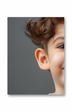 Cute young child with prominent protruding ears on a light background. Most commonly treated auricular deformity. Setback otoplasty banner.