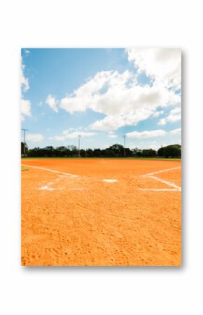 Empty Softball Field under blue sky with scattered clouds.