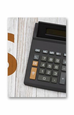  A black calculator with a gold dollar sign on wood desk
