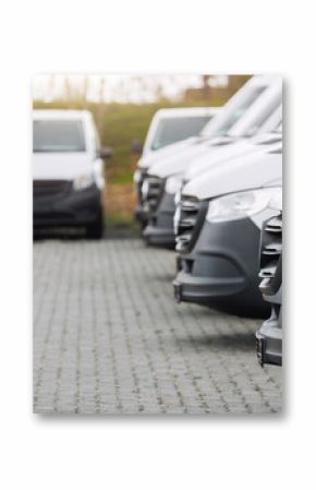 Fleet new modern electric hybrid hydrogen or diesel white vans parked in line row outdoors. Cargo freight industrial courier transportation logistics service. Commercial vehicle maintenance insurance