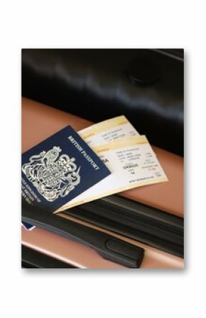 British passport with tickets lies on touristic suitcase close up in airport waiting hall
