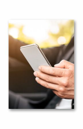 Driving safety concept. Cropped of businessman driving car, using mobile phone, checking location of business meeting, side view, copy space. Unrecognizable man using smartphone while driving