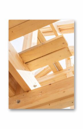 Close-up view of wooden beams and joints in a roof under construction, showcasing structural carpentry and joinery work in residential timber building.