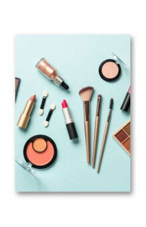 Beauty products for professional make up on blue background. Flat lay.
