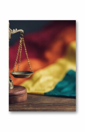 Scales of justice positioned against a blurred rainbow flag, symbolizing LGBTQ+ rights and the pursuit of equality and fairness in legal systems. : Generative AI