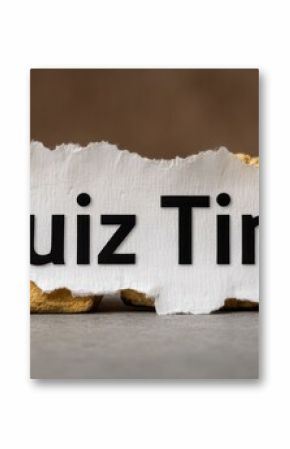 A torn piece of paper displays the text Quiz Time prominently. The natural texture in the background adds depth, creating an inviting and fun atmosphere for quizzes and trivia sessions