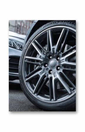 Modern vehicles parked on urban street showcasing sleek wheels and stylish design in daylight