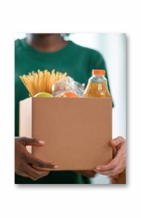 Charity workers wearing green t shirts holding cardboard box with food, helping people in need