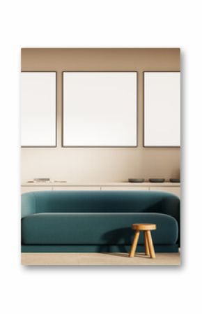 Framed blank posters on beige wall above modern teal sofa in minimal living room interior with wooden decor and soft neutral lighting ambiance concept. 3D Rendering