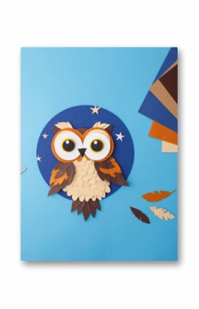 Flat lay of handmade paper owl and supplies for DIY crafts. Ideal for educational publishers, preschool content creators, kids toy packaging, hobby courses promotion