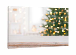 Bleached wood table top for your product presentation on deeply blurred Christmas fir tree lights interior background