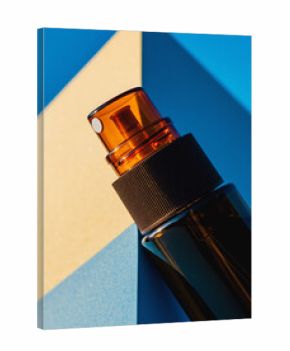 Close-up Amber Spray Bottle Mockup with Geometric Blue and Yellow Contrast