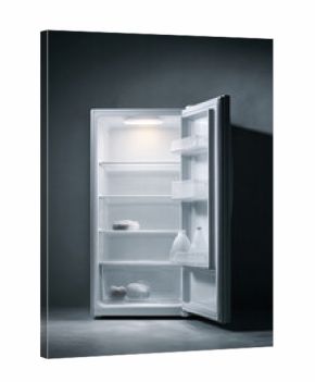 An open, nearly empty fridge with a stark, minimalist aesthetic. Conceptually represents scarcity, diet, or need. Could be used for food, lifestyle or health related content.