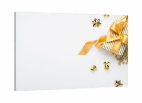 Merry Christmas and Happy Holidays greeting card, frame, banner. New Year. Golden Christmas decoration and gifts, presents on white background top view. Xmas holiday festive theme.