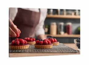 The Raspberry Tart Chef Arranging Fresh Berries on Homemade Pastry in Rustic Kitchen