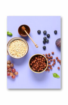 Tasty breakfast with oatmeal, corn balls and fruits on lilac background