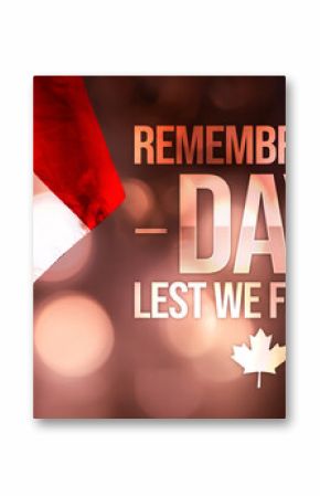 Remembrance Day, lest we forget with Canadian flag on the side along glowing bokeh lights. November 11 is observed as day to remember veterans in Canada, background