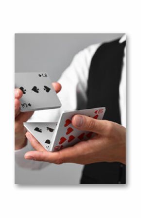 Professional croupier shuffling cards on grey background, closeup