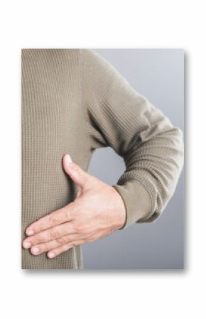 Man touches his left ribcage, showing signs of pain that may stem from rib muscle or cartilage inflammation. Discomfort associated with rib-related issues and the importance of musculoskeletal health