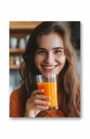 Happy young woman drinking carrot juice